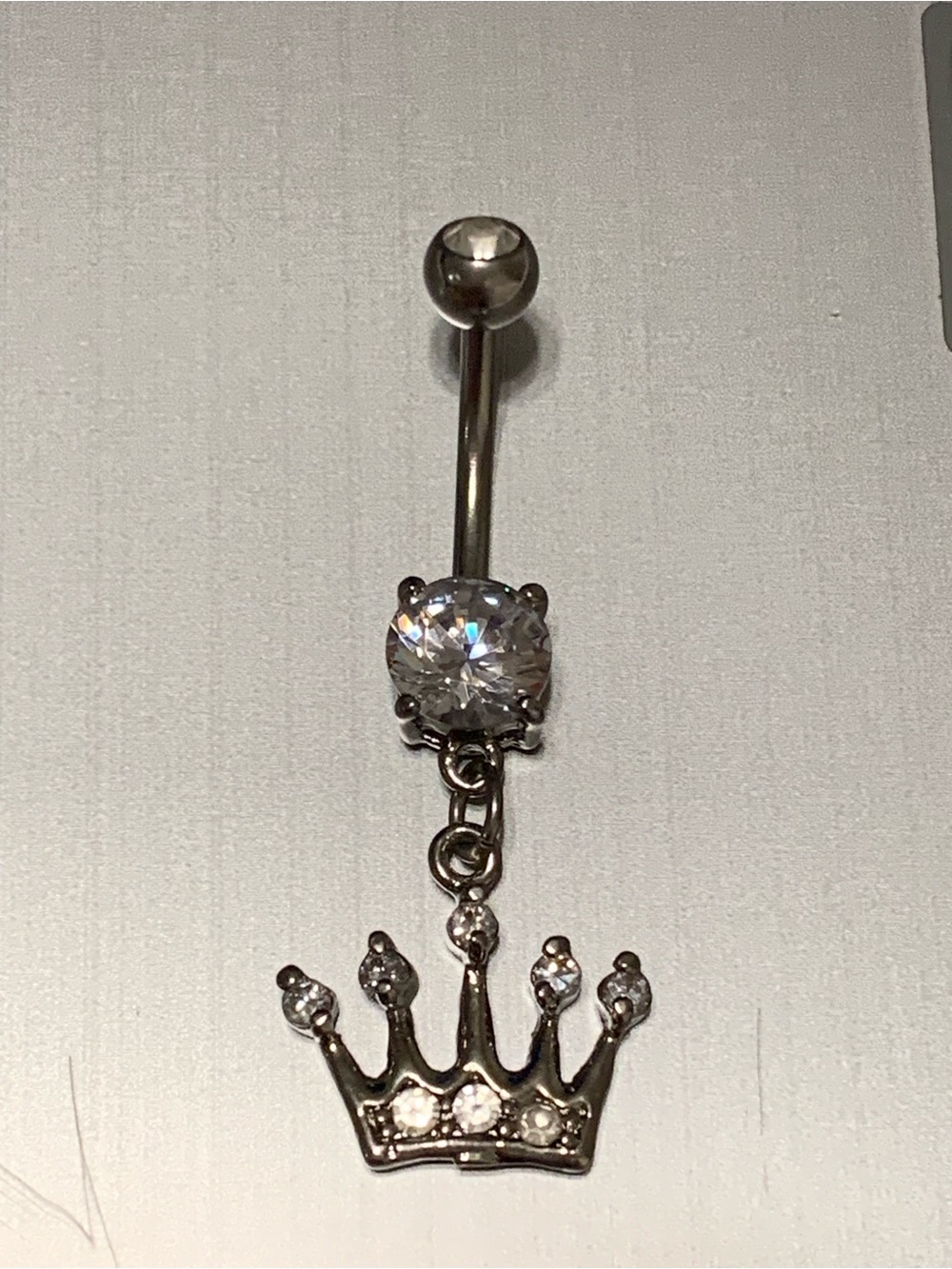 Silver tone Crystal Crown Dangle Navel Ring with Clear Cubic Zirconia.